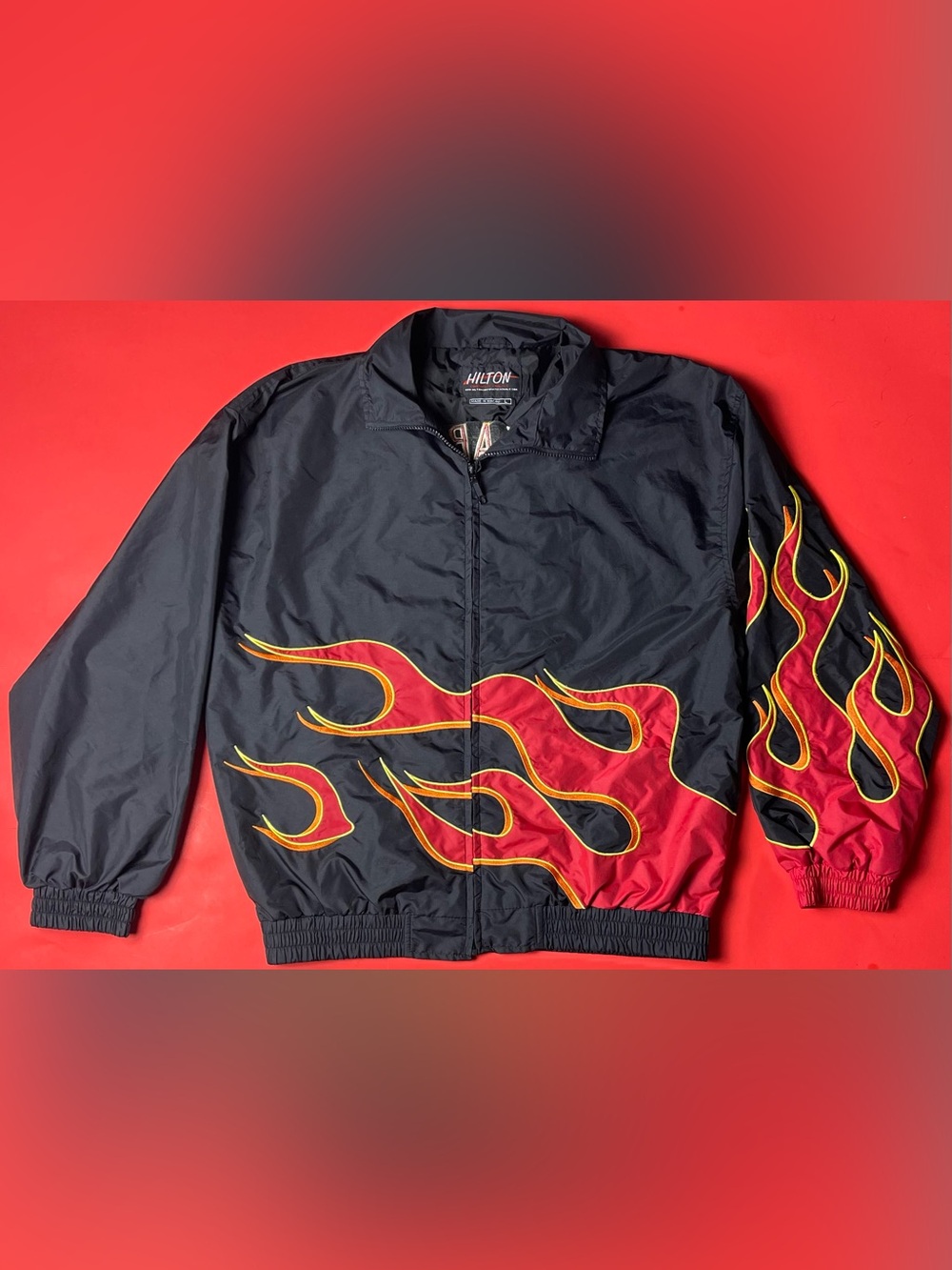 Hilton Black Windbreaker Jacket with Red Flame Design